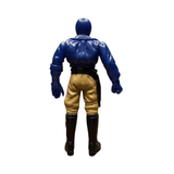 Back view of the Armored Captain Gatezone sofubi figure from Kamen Rider Black RX (1988). The figure wears a blue upper body suit with sculpted armor details, tan pants, and black boots. A black belt with a holster or strap hangs from the right side. The head is blue and helmeted, with arms positioned downward. The paintwork and sculpting reflect classic Showa-era craftsmanship, emphasizing its collectible value.