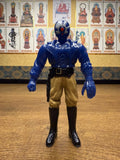Frontal view of the Armored Captain Gatezone sofubi figure from Kamen Rider Black RX (1988), showcasing a blue armored torso, tan pants, and black boots. The figure’s head features a blue helmet with a red circular element on the face, resembling a cybernetic or villainous design. A black belt with a holster is visible on the right hip. The figure stands upright with clenched fists, highlighting its combat-ready pose and stylized sculpting.