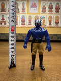 Side view of the Armored Captain Gatezone sofubi figure from Kamen Rider Black RX (1988), placed next to a vertical measuring tape indicating a height of approximately 10 centimeters. The figure has a blue upper body, tan pants, and black boots. The helmet is blue and silver with a red circular detail at the center. This image provides a clear size reference for collectors and sellers.