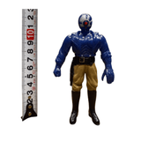 Side view of the Armored Captain Gatezone sofubi figure from Kamen Rider Black RX (1988), placed next to a vertical measuring tape indicating a height of approximately 10 centimeters. The figure has a blue upper body, tan pants, and black boots. The helmet is blue and silver with a red circular detail at the center. This image provides a clear size reference for collectors and sellers.