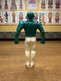 Rear view of the Naval Commander Bosgun sofubi figure from Kamen Rider Black RX (1988). The figure features a green helmet and upper body armor with sculpted ridges and shoulder pads, paired with white pants and boots. Minor black scuff marks are visible on the back of the legs, indicating age or play wear. The figure’s posture and paint application reflect classic 1980s Japanese toy design, emphasizing its collectible and nostalgic value.