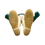 Close-up view of the underside of the Naval Commander Bosgun sofubi figure from Kamen Rider Black RX (1988), showing molded text and patterns on the soles of the shoes. The left sole is marked “CHINA” with additional faint characters, while the right sole has less legible molded details. The figure has green hands and off-white legs and shoes, confirming its soft vinyl construction and manufacturing origin—useful for authenticity verification and collector cataloging.