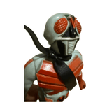 Detailed close-up of the Kamen Rider X figure’s head and upper torso. The helmet features large red compound eyes, a black mouthpiece, and a red “V” crest on the forehead. The body is painted light blue and red, with a black scarf around the neck. The sculpting reflects the insect-inspired design typical of Showa-era Kamen Rider aesthetics.