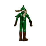 Full rear view of the Kamen Rider Amazon sofubi figure, featuring a green body, dark brown boots and gloves, and a silver scarf flowing to the side. The helmet has a pointed crest and the right shoulder includes a sculpted spike. The figure stands upright with arms slightly bent, showcasing Showa-era sculpting and the unique limb coloration.