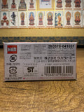 Bottom of the Tomica Premium TP16 Honda CR-X box showing manufacturing details, safety warnings, and Takara Tomy customer service info, placed against a wall with religious artwork.