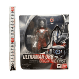 Boxed Ultraman Orb Origin The First S.H.Figuarts figure with a clear window displaying the red and silver figure. A measuring tape beside the box shows packaging height of approximately 20 cm. Includes branding and character illustration.