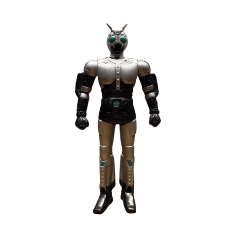 Frontal view of the Shadowmoon sofubi figure from Kamen Rider Black (1988), showcasing its iconic silver armor with black accents, riveted chest plating, and shoulder pads. The helmet features green compound eyes and twin antennae, while the belt displays a green circular emblem at the center. The figure’s upright pose and detailed sculpting capture the character’s cyborg-insect hybrid design, making it a standout piece for tokusatsu collectors.