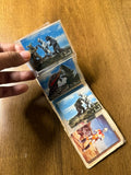 Two vintage trading cards in a plastic sleeve. The left card features four black-suited helmeted characters with weapons and one colorful character in a barren landscape. The right card shows a blue-suited hero kicking a soccer ball in a grassy field, wearing a red-and-white chest emblem and red leg patches. Partial copyright text “© TOEI NET” is visible, linking the cards to Himitsu Sentai Goranger and Toei’s tokusatsu productions.