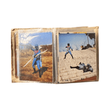Two vintage Japanese tokusatsu trading cards stored in a plastic sleeve. The left card shows a blue-suited superhero aiming a bow at a villain on a staircase. The right card features the same hero wielding a weapon against a brightly colored villain with a sun-like face and yellow cape. Both cards include elaborate costumes and dramatic action poses typical of 1970s–80s Himitsu Sentai Goranger scenes. Copyright text “©石森プロ・NET・東映” is visible, confirming official production origins.