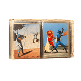 Two vintage tokusatsu trading cards in a plastic sleeve. The left card depicts a blue-helmeted hero standing in a dry grassy field holding a white bow or staff. The right card shows the same character in combat on a stone staircase, with a silver-costumed opponent lying defeated. The bottom of the right card includes “© 石森プロ・NET・東映,” confirming its connection to Himitsu Sentai Goranger. The cards reflect classic Japanese superhero action and dramatic outdoor settings.