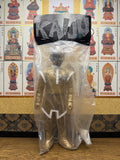 Full view of the Shapley Alien sofubi figure in sealed packaging. The header card features the word “KAIJU” in stylized, jagged font on a black and silver background. The figure is dressed in a metallic gold bodysuit with white trim, white boots, and a silver helmet with perforated detailing. The clear bag allows full visibility of the figure’s sculpt and paintwork, ideal for collectors.