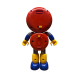 Back view of the Batten Robomaru GB-94 toy robot, showing a red circular head and torso with multiple screw holes and a battery compartment. A yellow ON/OFF switch is located on the back of the head, and a yellow knob is positioned on the torso. The arms are blue with flexible black shoulder joints, and the legs are yellow with blue feet. The design suggests electronic or interactive features, enhancing its playability and mechanical appeal.