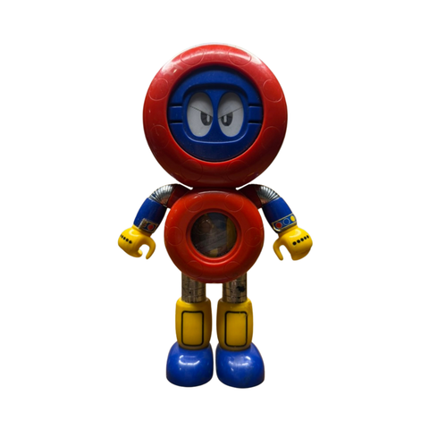 Full-body view of the Batten Robomaru GB-94 toy robot, showcasing its vibrant and stylized design. The figure has a large red circular head with a blue face and expressive eyes, a red torso with a transparent window revealing internal components, blue arms with yellow claw-shaped hands, and metallic legs with yellow and blue boots. The playful color scheme and character details highlight its appeal as a vintage children’s toy and collectible.