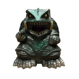 "Stylized figurine of a monstrous turtle with a green body and metallic silver accents. The shell features hexagonal patterns, and the creature has sharp claws, large round eyes, and an open mouth filled with pointed teeth. The intense expression and detailed sculpting suggest a fantasy or sci-fi collectible toy."